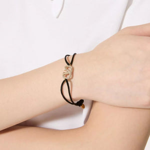 PULSERA DE TELA V CON ZIRCONIA